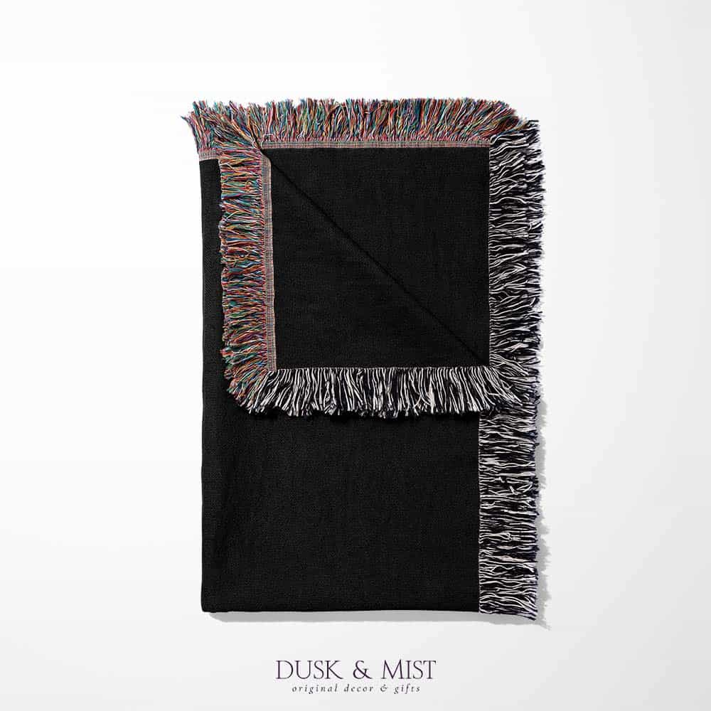 Woven cotton blanket featuring a red dragon wrapped around a golden sword on a black background with intricate wing and scale details.