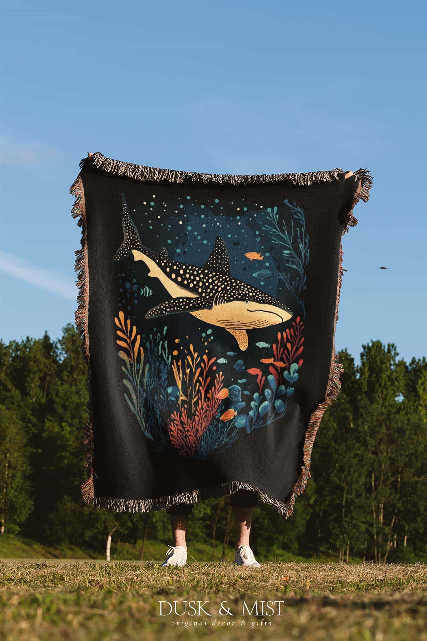 Blanket with whale shark and ocean life design on a black background