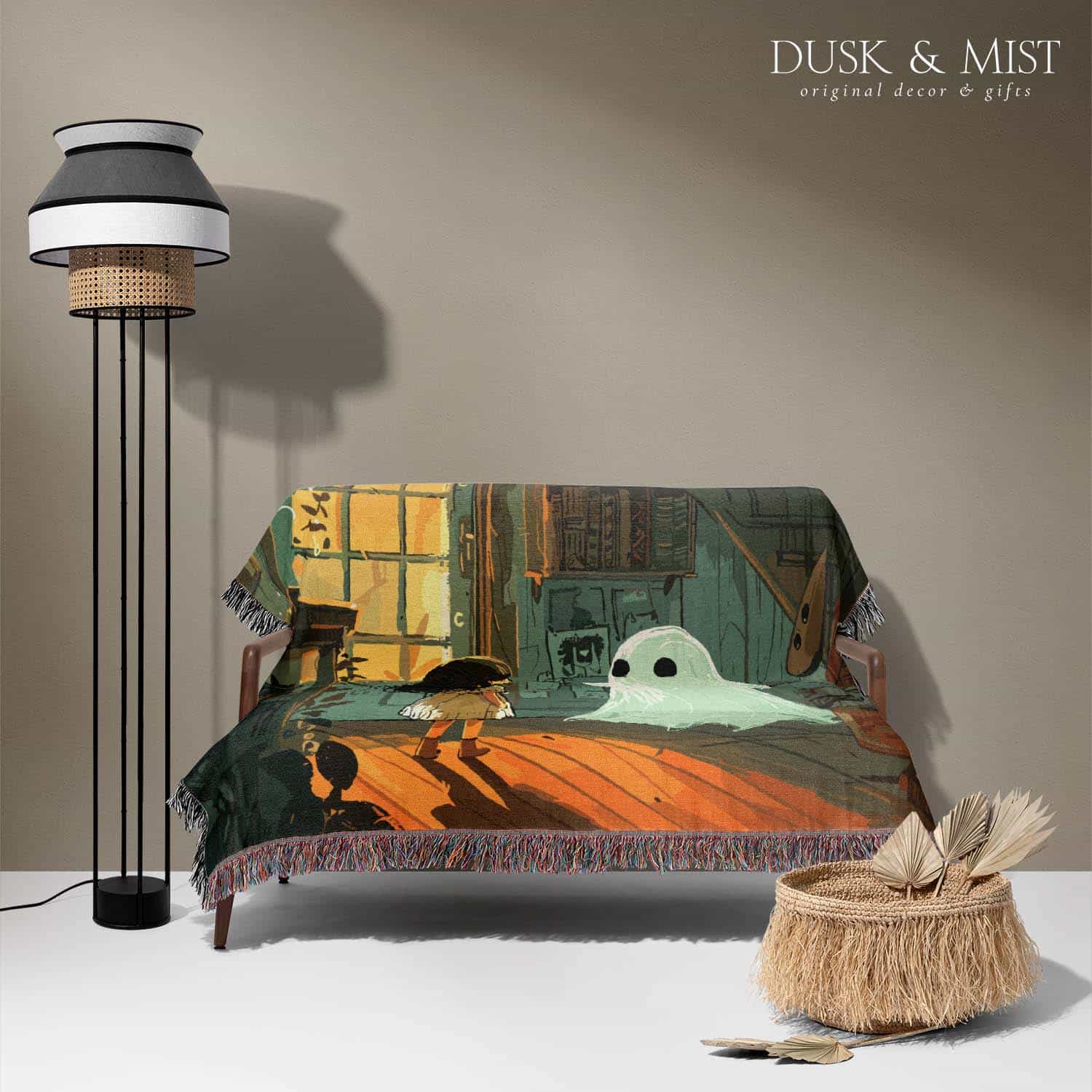 Woven cotton blanket depicting a small ghost and a young girl standing in a warmly lit wooden room filled with plants, books, and soft evening light streaming through a door.