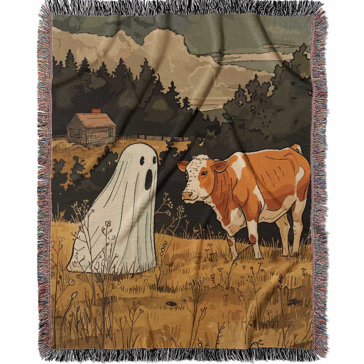 Woven cotton blanket featuring a small ghost standing in a golden meadow facing a brown and white cow, with a rustic cabin and forested hills in the background.