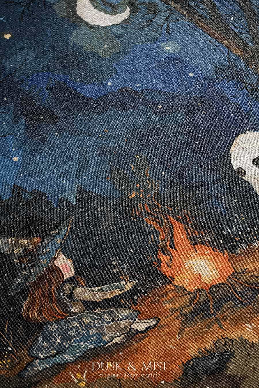 Woven cotton blanket featuring a witch and a ghost sitting by a campfire under a crescent moon in a dark forest setting.