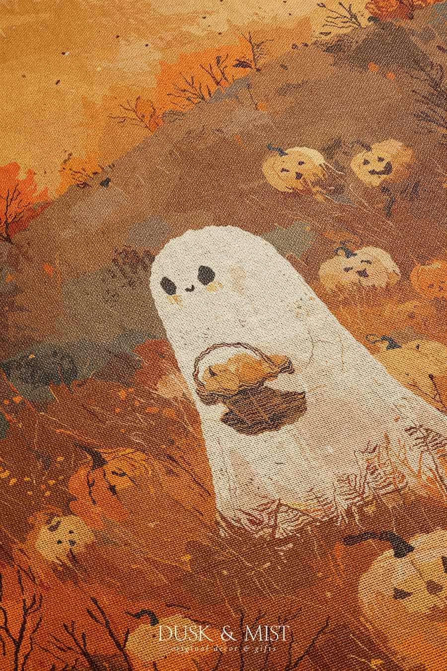 Woven cotton blanket showing a small ghost holding a basket, surrounded by pumpkins and autumn foliage in warm golden and orange tones.