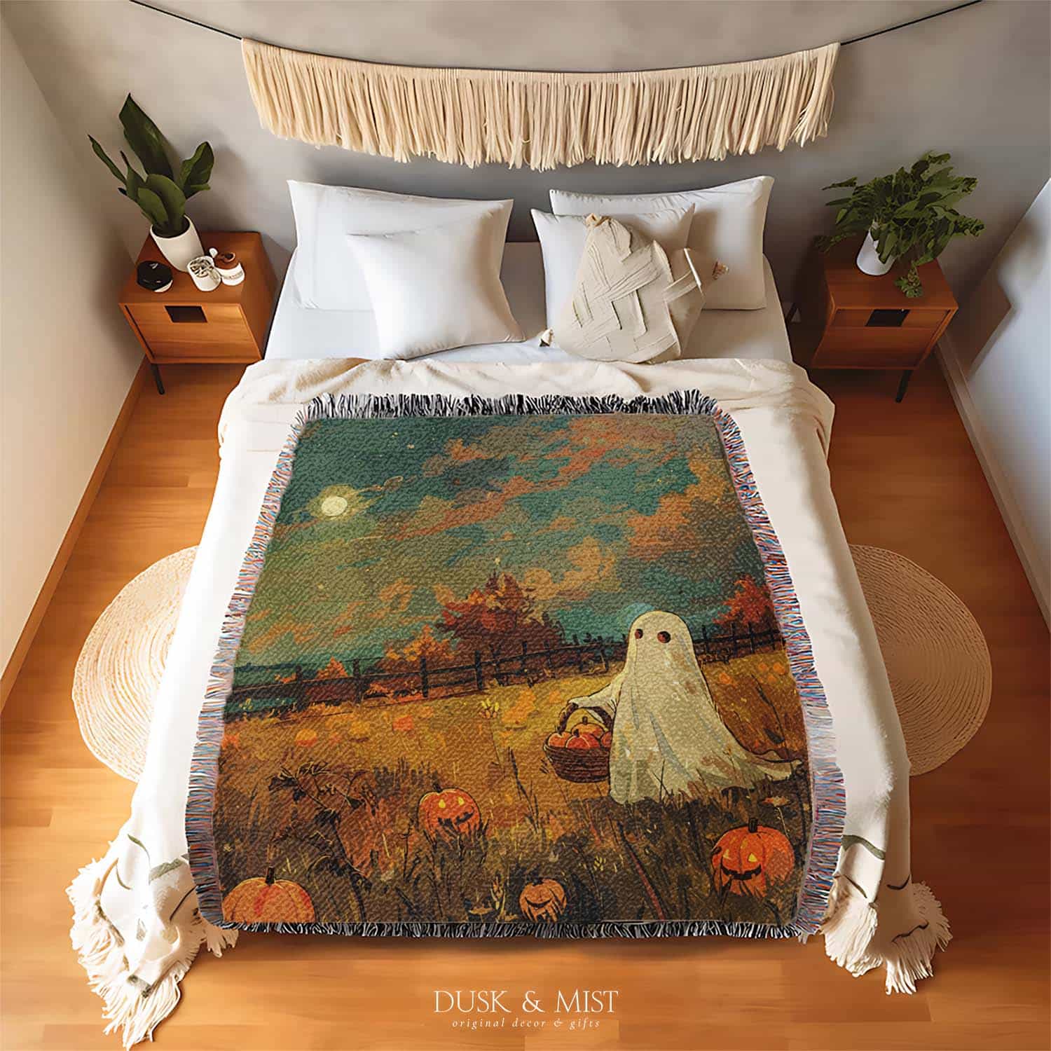 Woven cotton blanket depicting a ghost carrying a basket in a pumpkin-filled autumn field under a twilight sky.  