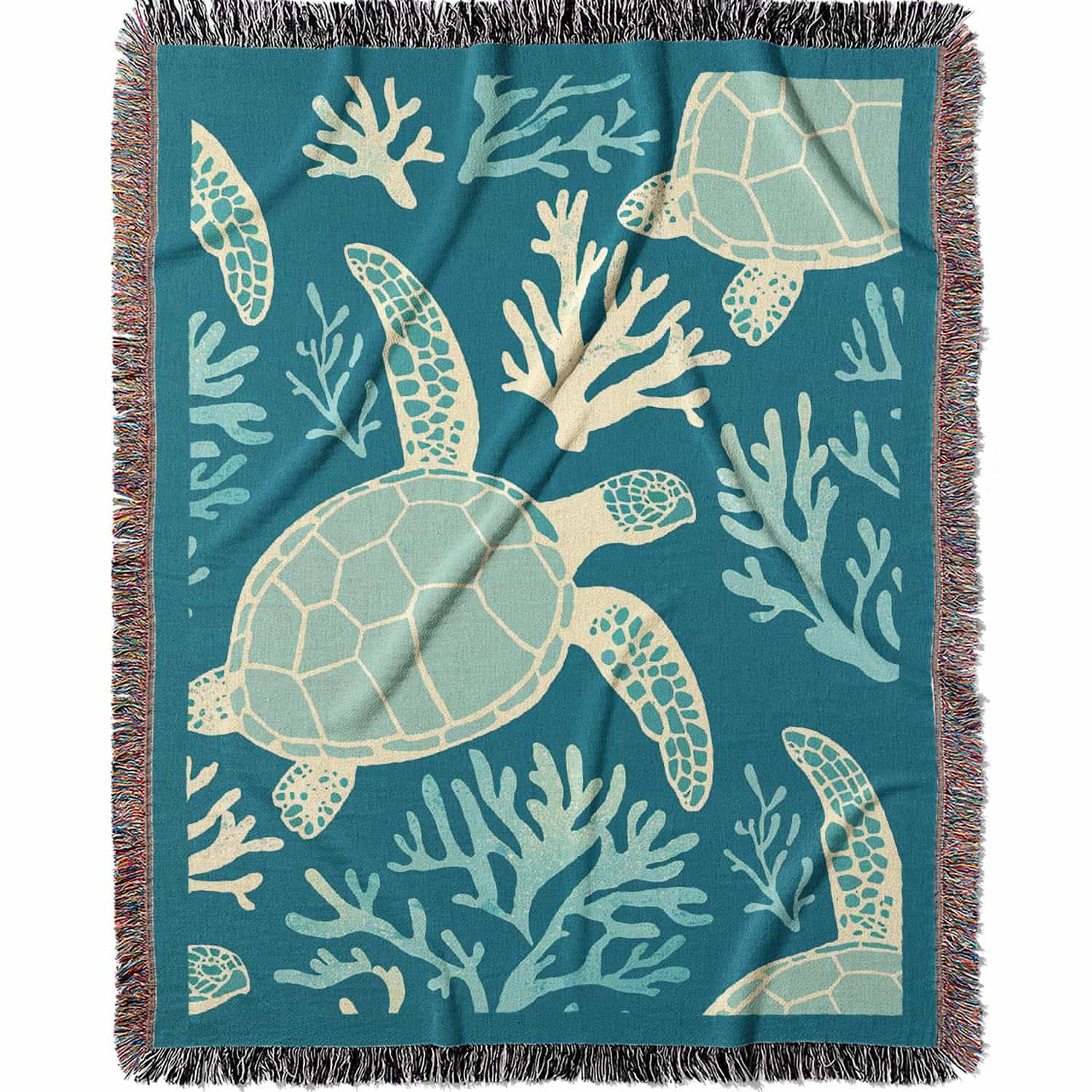 Woven cotton blanket featuring sea turtles swimming among light blue coral on a teal background.  