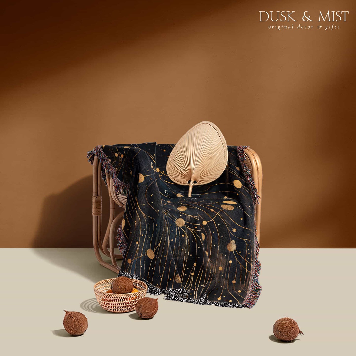Woven cotton blanket featuring a profile of a woman with flowing hair illustrated as starry constellations, accented with golden moons and celestial motifs on a dark background.