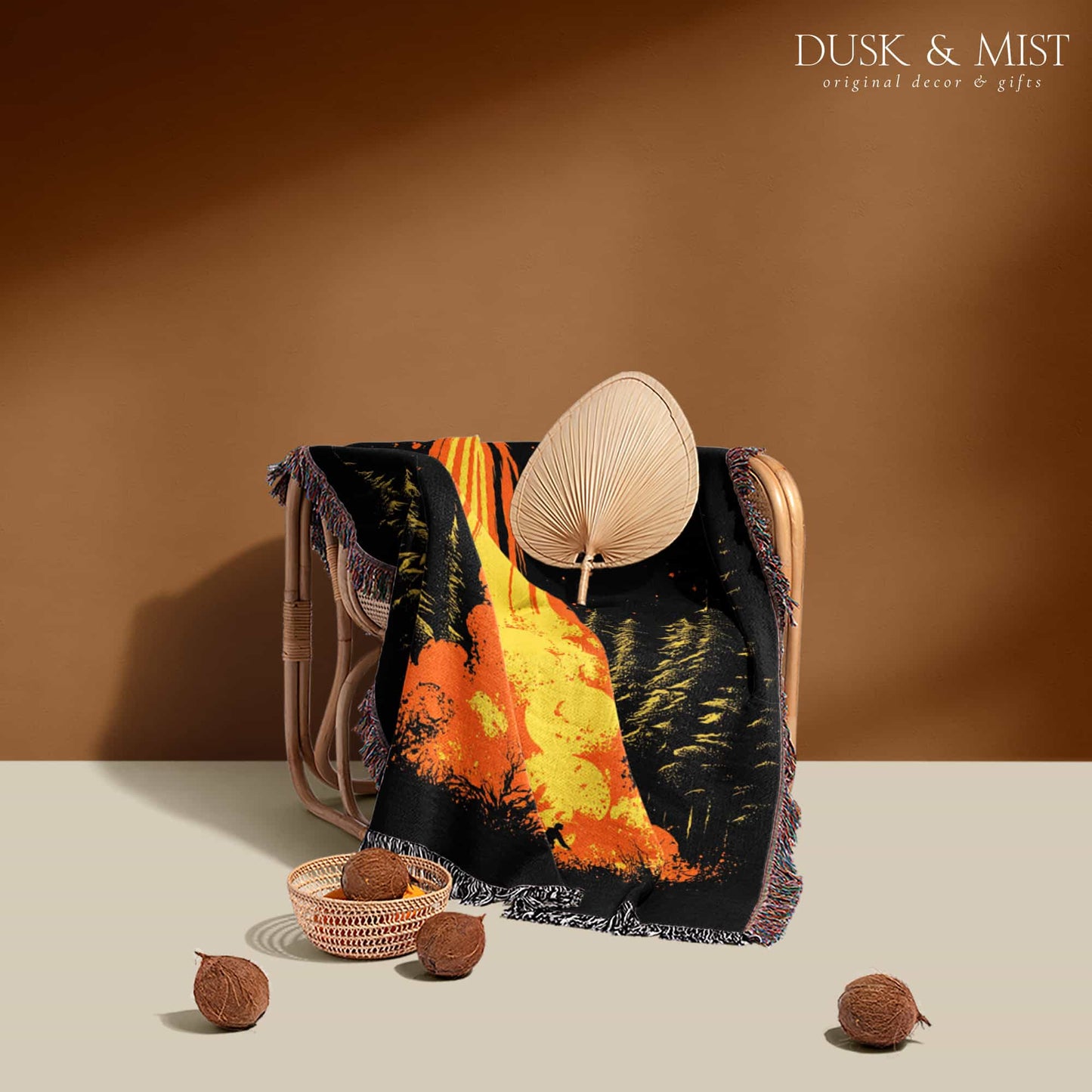 Woven cotton blanket featuring a UFO with a fiery orange beam blasting into a forest, with smoke clouds and a small human silhouette running at the bottom.
