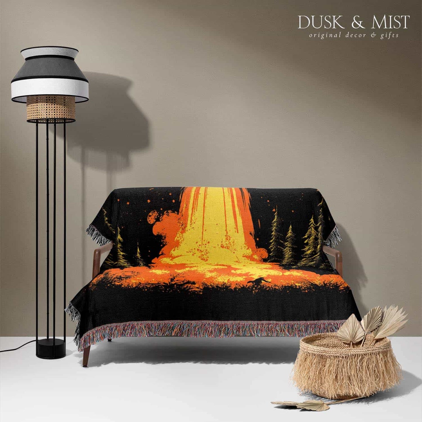 Woven cotton blanket featuring a UFO with a fiery orange beam blasting into a forest, with smoke clouds and a small human silhouette running at the bottom.