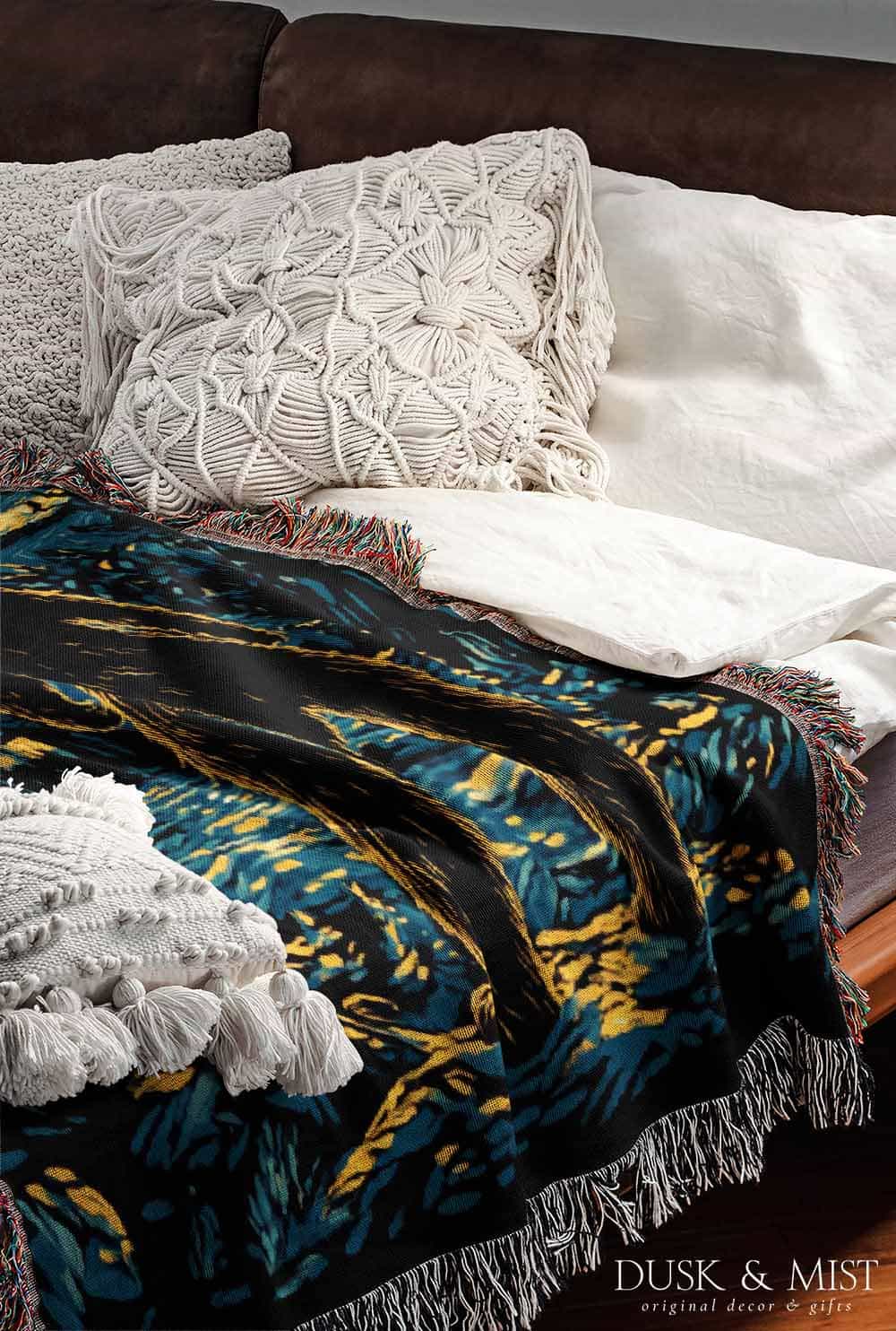 Woven cotton blanket featuring Bigfoot in a forest beneath a Van Gogh-style starry night sky with swirling constellations and moonlight.