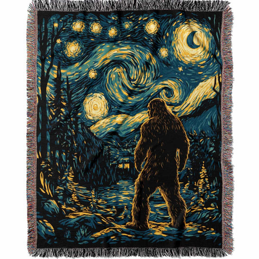 Woven cotton blanket featuring Bigfoot in a forest beneath a Van Gogh-style starry night sky with swirling constellations and moonlight.