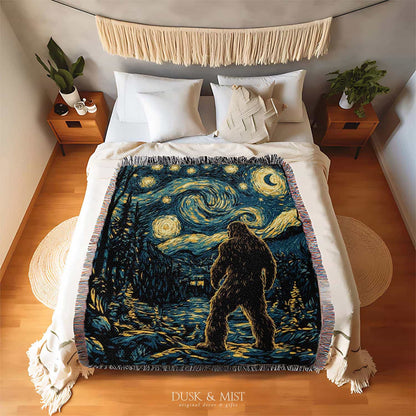Woven cotton blanket featuring Bigfoot in a forest beneath a Van Gogh-style starry night sky with swirling constellations and moonlight.