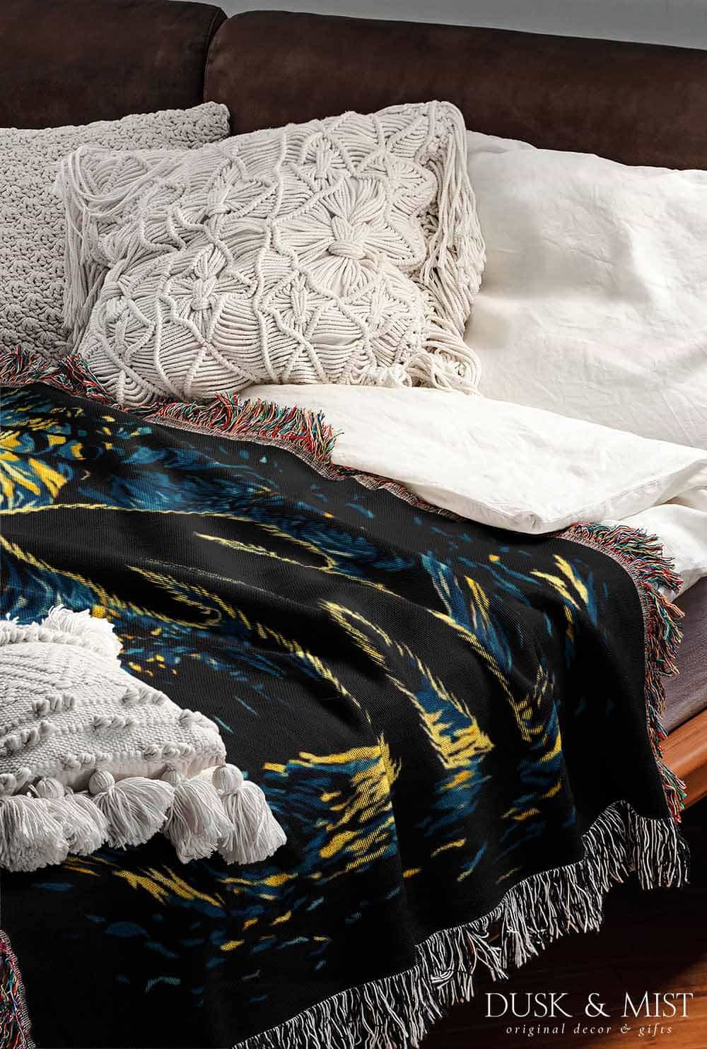 Woven cotton blanket featuring Bigfoot in silhouette against a Van Gogh-style starry night sky with swirling golden stars and dark forest trees.