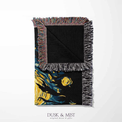 Woven cotton blanket featuring Bigfoot in silhouette against a Van Gogh-style starry night sky with swirling golden stars and dark forest trees.
