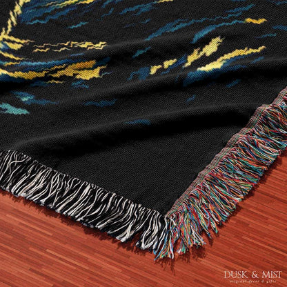 Woven cotton blanket featuring Bigfoot in silhouette against a Van Gogh-style starry night sky with swirling golden stars and dark forest trees.
