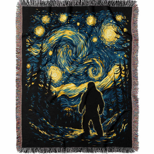 Woven cotton blanket featuring Bigfoot in silhouette against a Van Gogh-style starry night sky with swirling golden stars and dark forest trees.