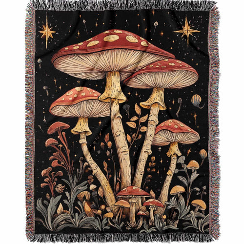 Woven cotton blanket featuring tall red-capped mushrooms under a starry sky with golden stars and surrounding plants on a black background.