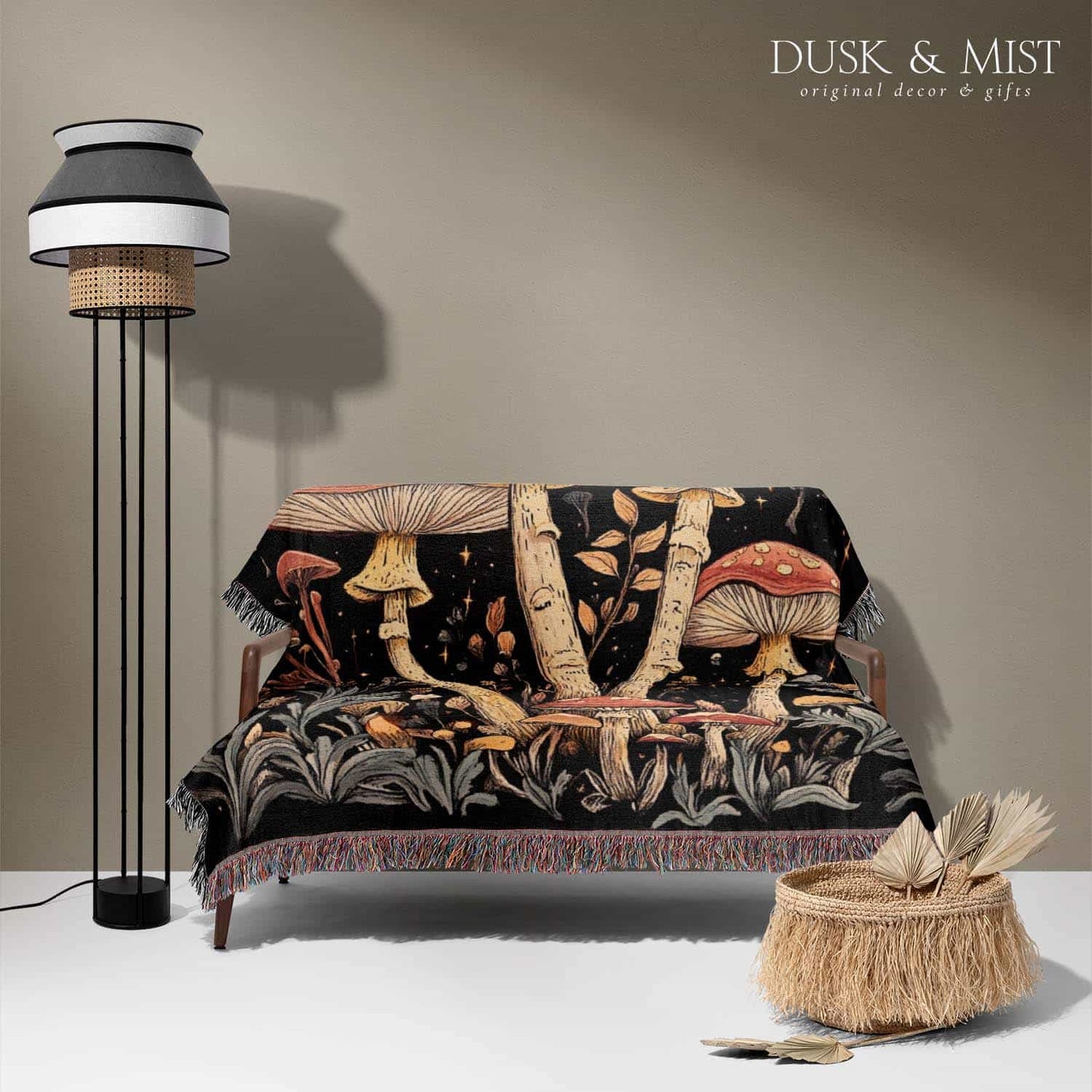 Woven cotton blanket featuring tall red-capped mushrooms under a starry sky with golden stars and surrounding plants on a black background.