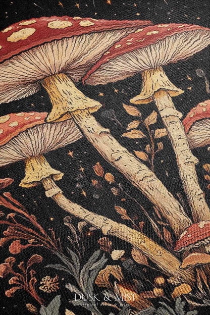 Woven cotton blanket featuring tall red-capped mushrooms under a starry sky with golden stars and surrounding plants on a black background.