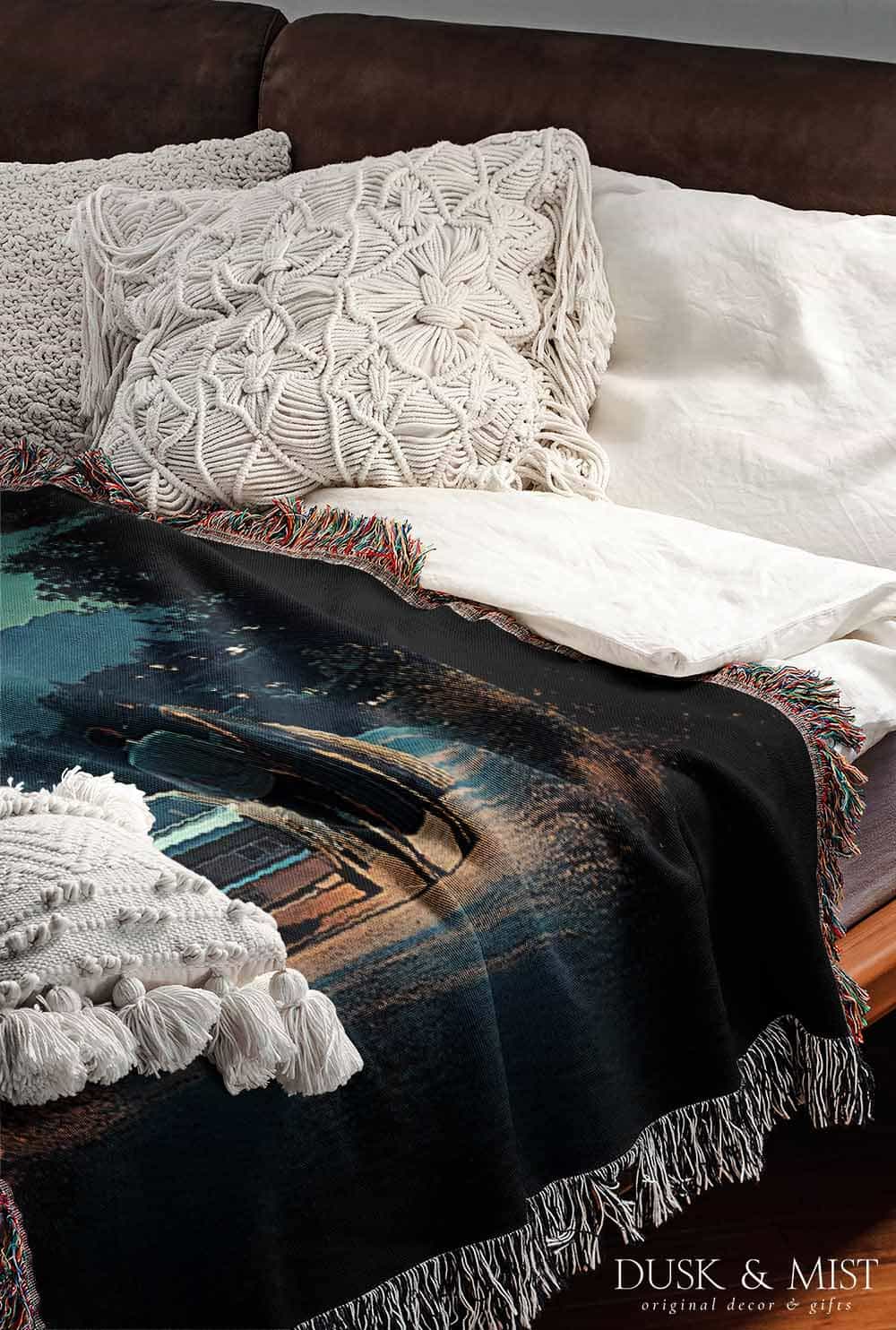 Woven cotton blanket featuring a UFO beaming light onto a couple standing near a car at night, with a starry sky and silhouetted trees.