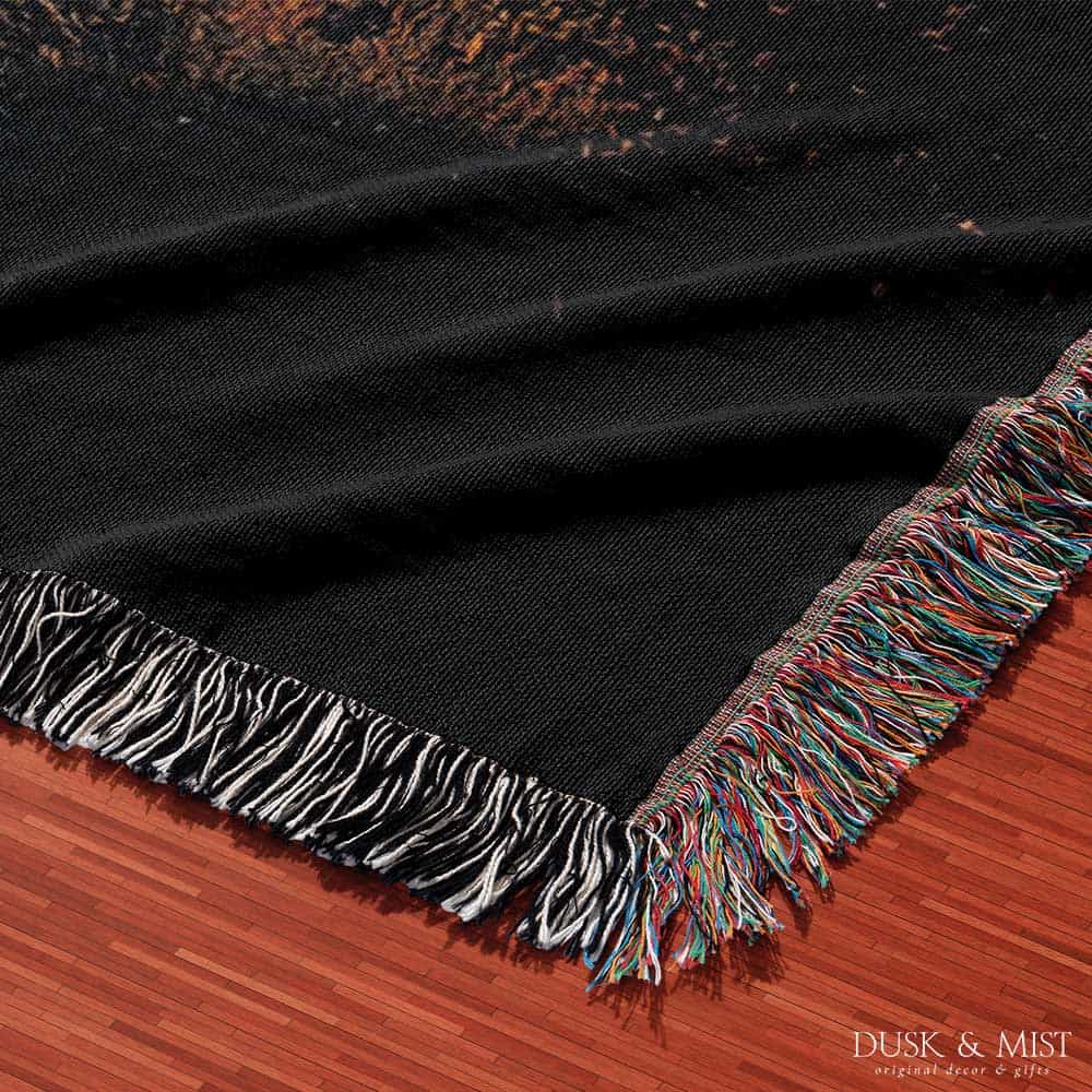 Woven cotton blanket featuring a UFO beaming light onto a couple standing near a car at night, with a starry sky and silhouetted trees.