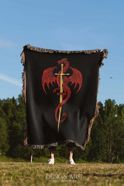 Woven cotton blanket featuring a red dragon wrapped around a golden sword on a black background with intricate wing and scale details.