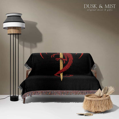 Woven cotton blanket featuring a red dragon wrapped around a golden sword on a black background with intricate wing and scale details.