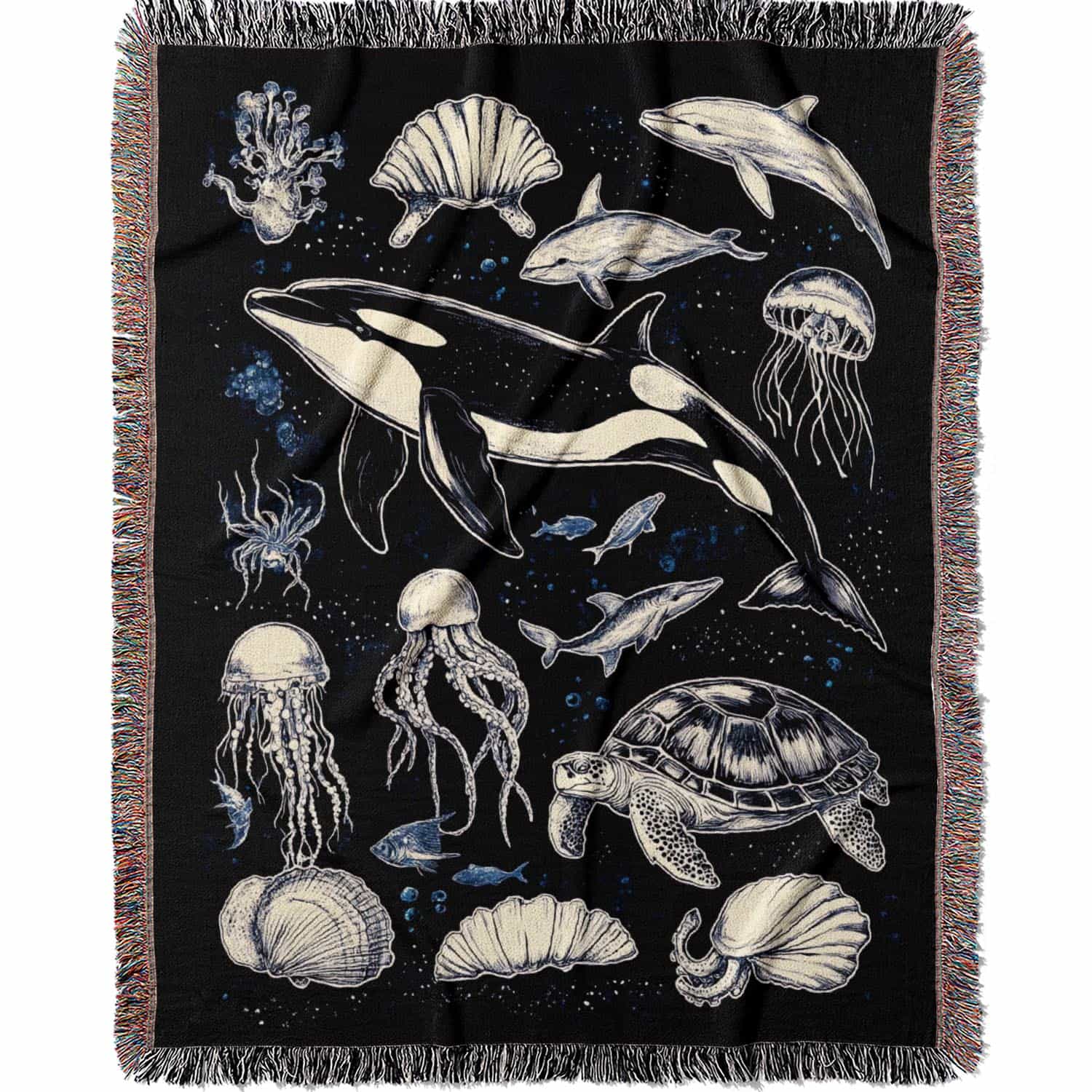 Woven cotton blanket featuring detailed marine life illustration — orca, dolphins, sea turtle, octopus, jellyfish, seashells, and fish on a black background.