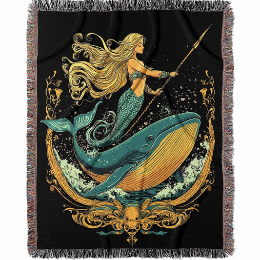 Woven cotton blanket featuring a warrior mermaid with flowing hair riding a whale, holding a spear, surrounded by ornate golden oceanic patterns.