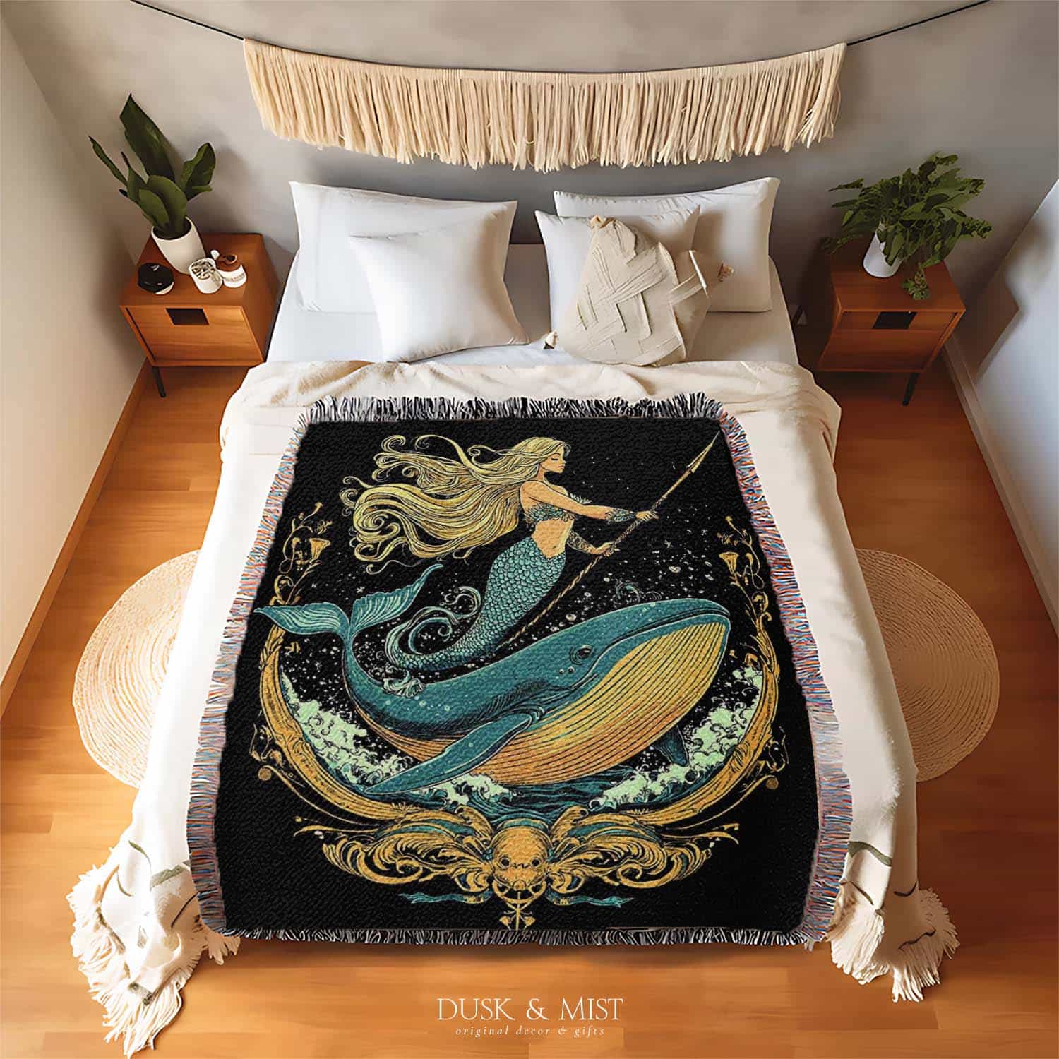 Woven cotton blanket featuring a warrior mermaid with flowing hair riding a whale, holding a spear, surrounded by ornate golden oceanic patterns.