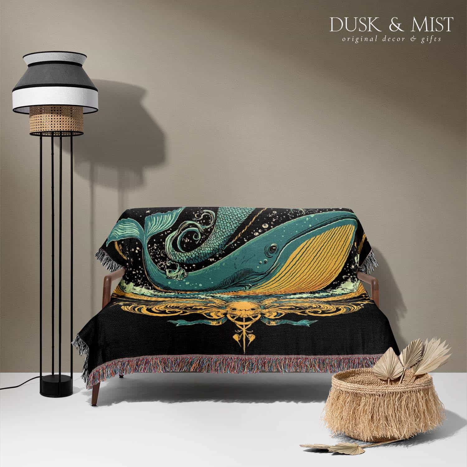 Woven cotton blanket featuring a warrior mermaid with flowing hair riding a whale, holding a spear, surrounded by ornate golden oceanic patterns.