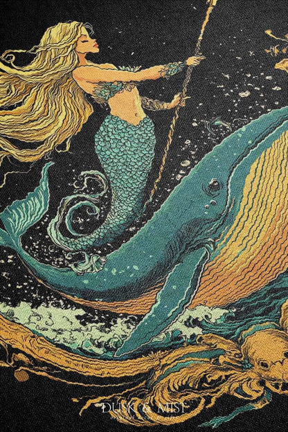 Woven cotton blanket featuring a warrior mermaid with flowing hair riding a whale, holding a spear, surrounded by ornate golden oceanic patterns.