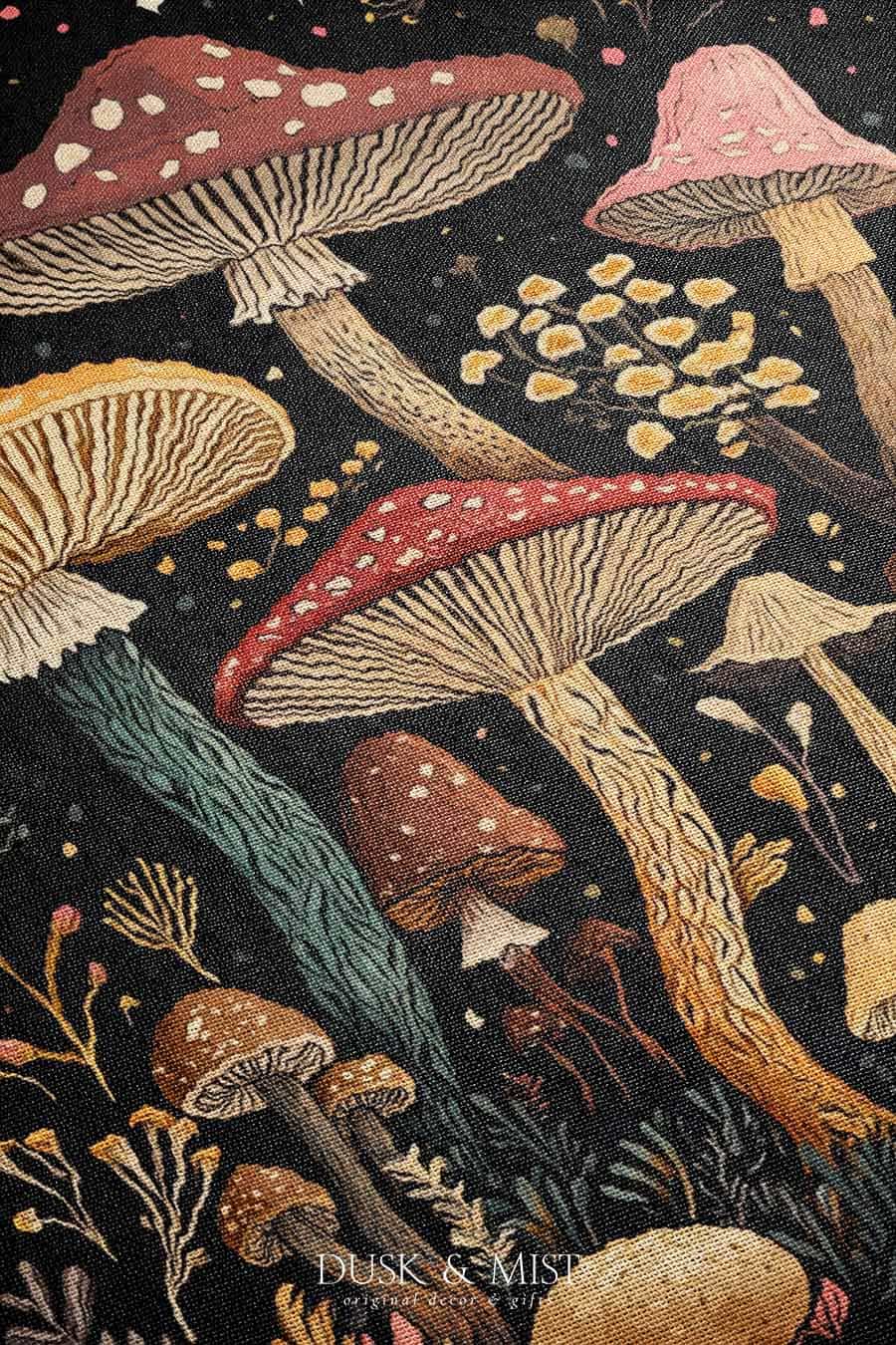 Woven cotton blanket featuring a botanical-style field of mushrooms in red, gold, and cream tones with surrounding plants and foliage on a black background.