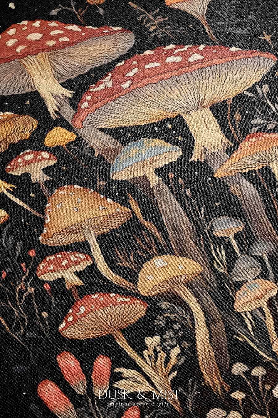 Woven cotton blanket showing a colorful cluster of mushrooms in red, gold, blue, and cream caps with surrounding plants and flowers on a black background.