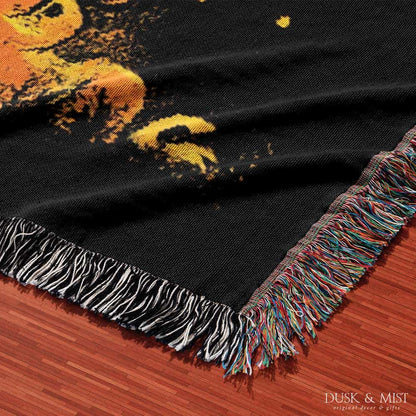 Woven cotton blanket featuring a UFO casting a golden beam into the forest at night, with glowing clouds and cosmic light effects.