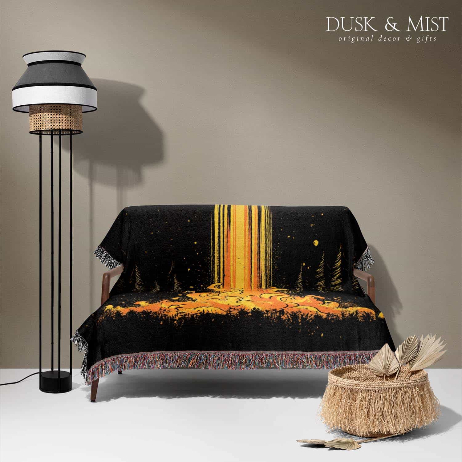 Woven cotton blanket featuring a UFO casting a golden beam into the forest at night, with glowing clouds and cosmic light effects.