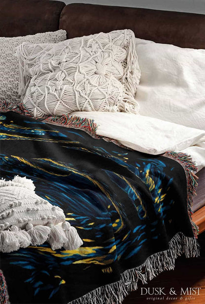 Woven cotton blanket featuring Sasquatch walking through a forest under a Van Gogh-style starry night sky with swirling stars and moonlight.