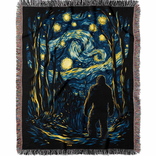 Woven cotton blanket featuring Sasquatch walking through a forest under a Van Gogh-style starry night sky with swirling stars and moonlight.