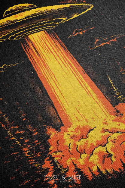 Woven cotton blanket featuring a UFO with a fiery orange beam illuminating a dark forest, with glowing clouds and night sky details.