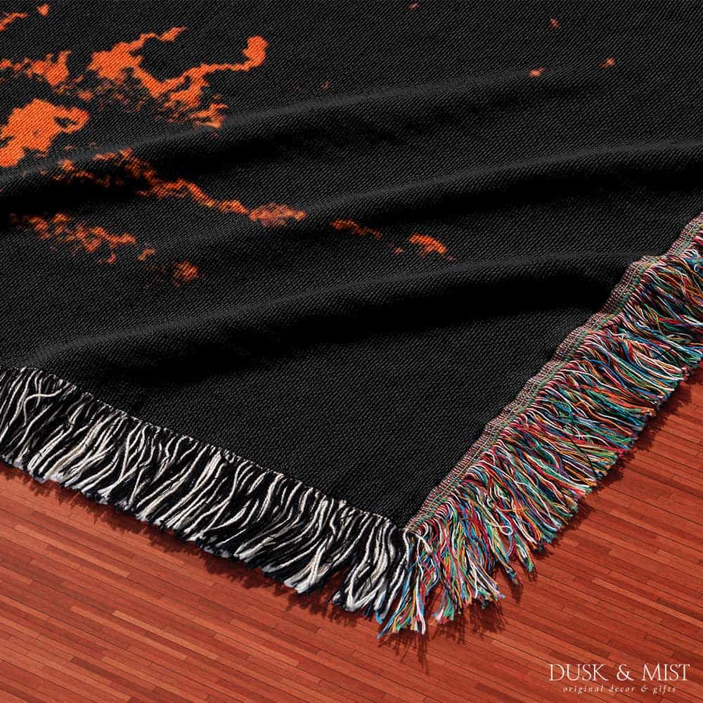 Woven cotton blanket featuring a UFO with a fiery orange beam blasting into a dark forest, with glowing explosions and cosmic night details.