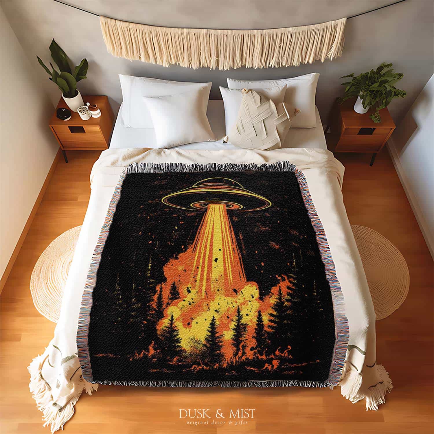 Woven cotton blanket featuring a UFO with a fiery orange beam blasting into a dark forest, with glowing explosions and cosmic night details.