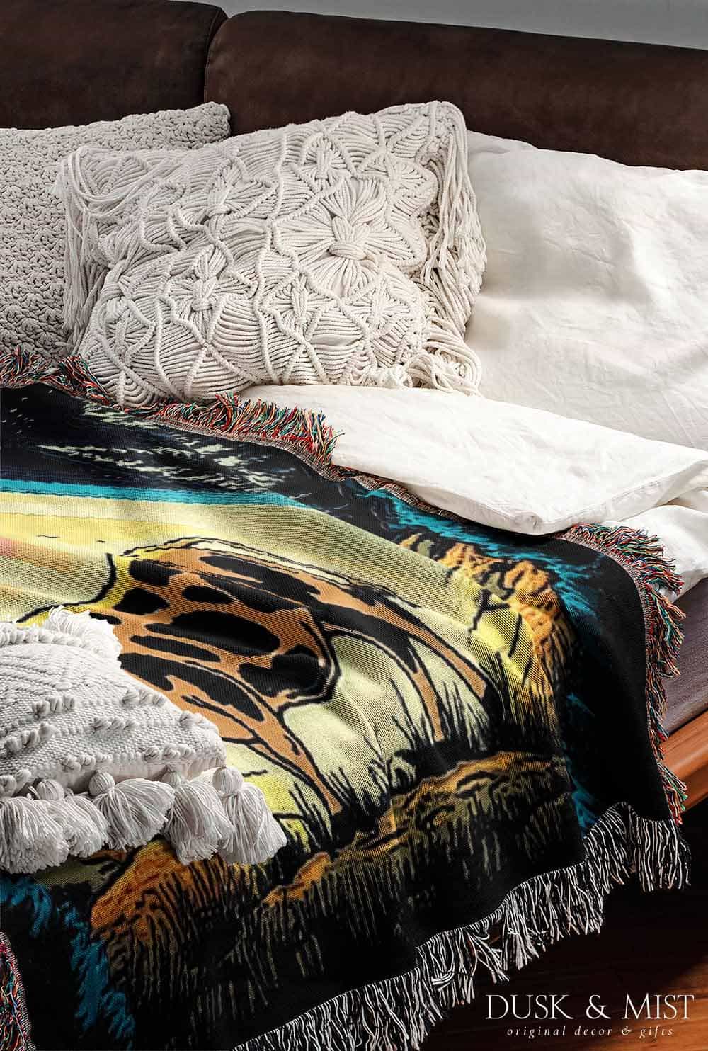 Blanket with a UFO abduction of a cow design against a starry night sky.